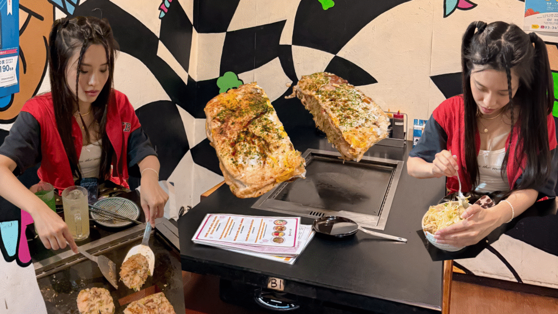 Tokyo travel experience at Sakura Tei in Harajuku – DIY okonomiyaki cooking. Tourists preparing Japanese savory pancakes on a hot grill inside the colorful restaurant.