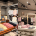 A side-by-side photo collage showing the interior of the Hollister store at DiverCity Tokyo Plaza, featuring classic casual women's dresses and denim on the left, and the Gilly Hicks activewear section with pastel pink workout outfits on the right.